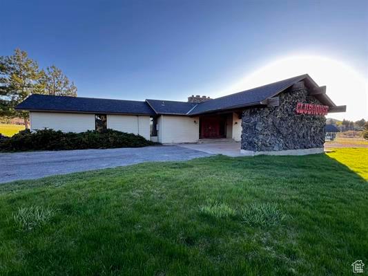 1204 Nashua Cir, Soda Springs, ID 83276 - view of front facade featuring driveway, a front yard, and stone siding