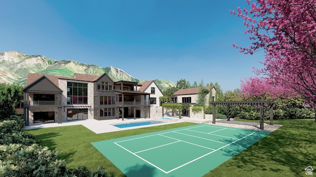view of community featuring a pergola, a patio area, a lawn, and a mountain view