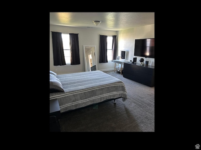 carpeted bedroom featuring baseboards