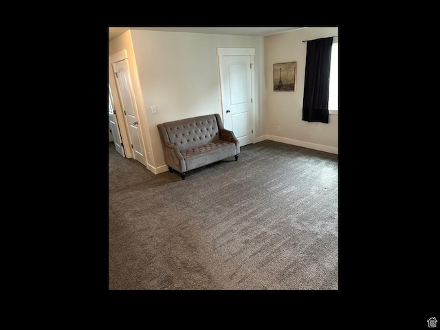 sitting room with baseboards and carpet floors