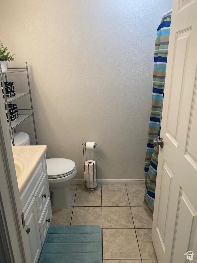 8027 W Copperfield Pl S # 12, Magna, UT 84044 - bathroom with vanity, toilet, tile patterned flooring, and baseboards