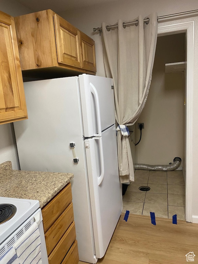 8027 W Copperfield Pl S # 12, Magna, UT 84044 - kitchen featuring light tile patterned floors and freestanding refrigerator