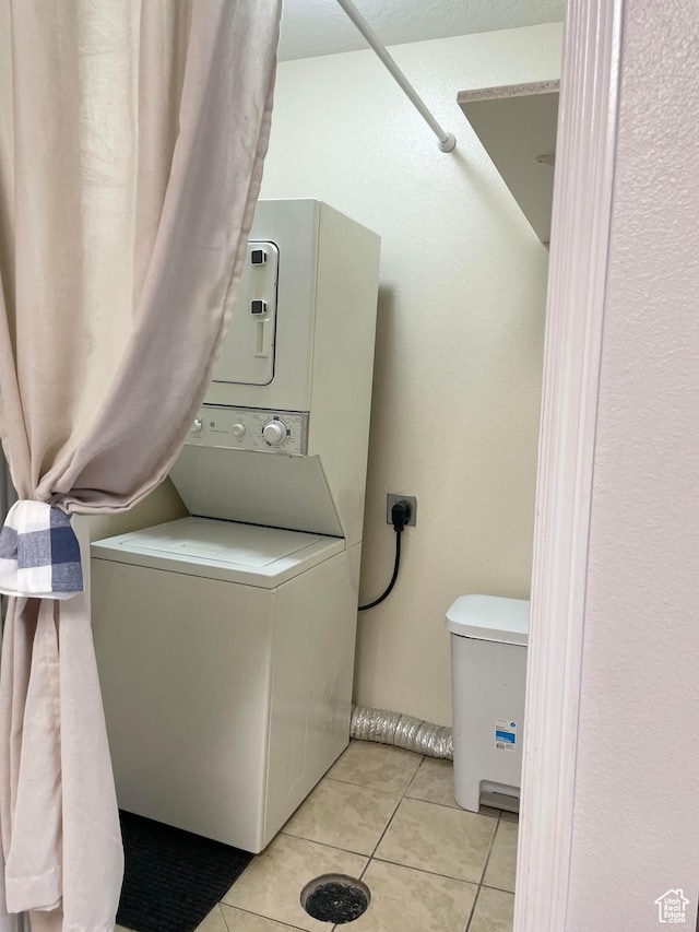 8027 W Copperfield Pl S # 12, Magna, UT 84044 - laundry area featuring stacked washer / drying machine and light tile patterned floors