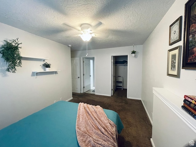 8027 W Copperfield Pl S # 12, Magna, UT 84044 - carpeted bedroom featuring baseboards, a textured ceiling, ceiling fan, a closet, and a spacious closet