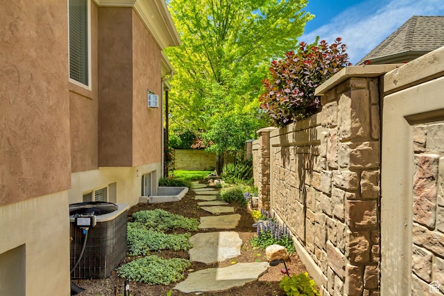 view of yard featuring central AC unit and fence