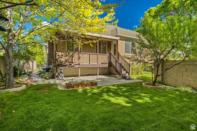 rear view of property with a patio area and stucco siding