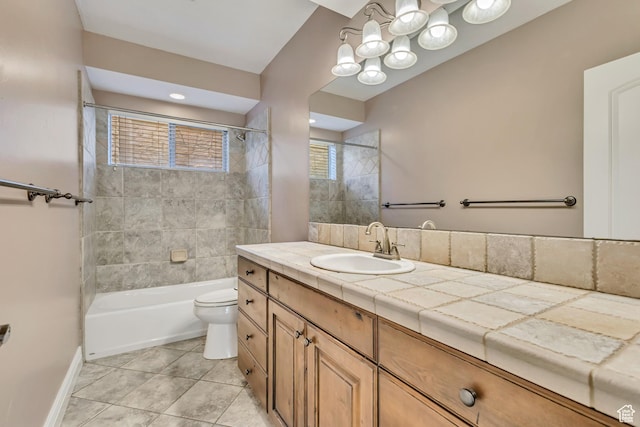 bathroom featuring toilet, tile patterned floors, vanity, shower / bath combination, and baseboards
