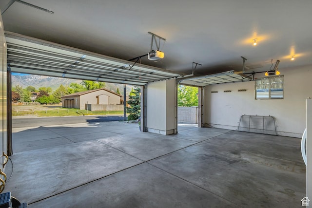 garage featuring a garage door opener and a mountain view