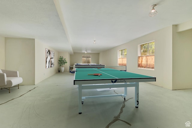 recreation room with concrete flooring