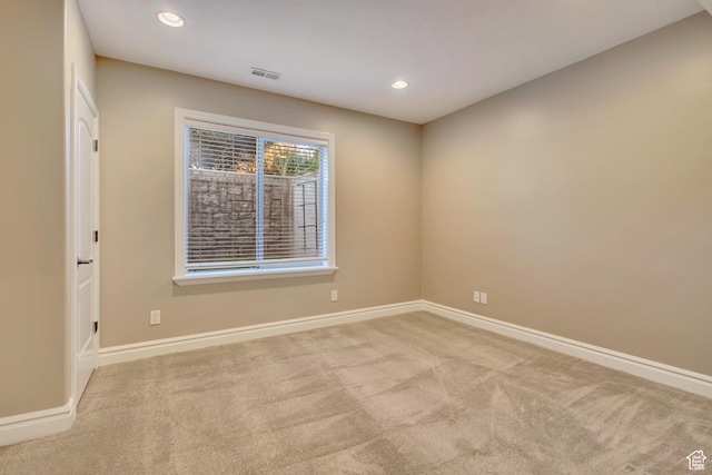 spare room featuring carpet flooring, baseboards, and recessed lighting