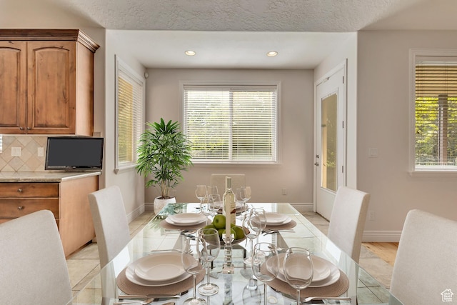 dining space featuring healthy amount of natural light, recessed lighting, and baseboards
