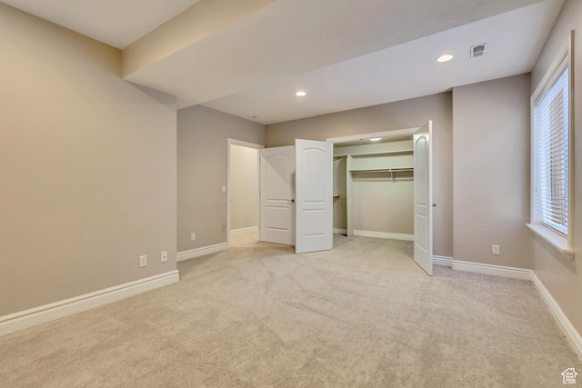 unfurnished bedroom featuring recessed lighting, light colored carpet, and baseboards