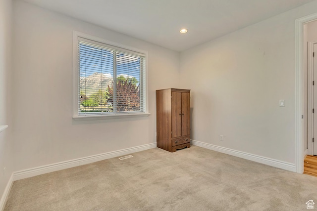 spare room featuring baseboards, carpet flooring, and recessed lighting