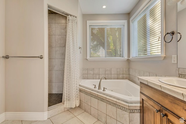 bathroom featuring a tub with jets, tile patterned flooring, a shower stall, and vanity
