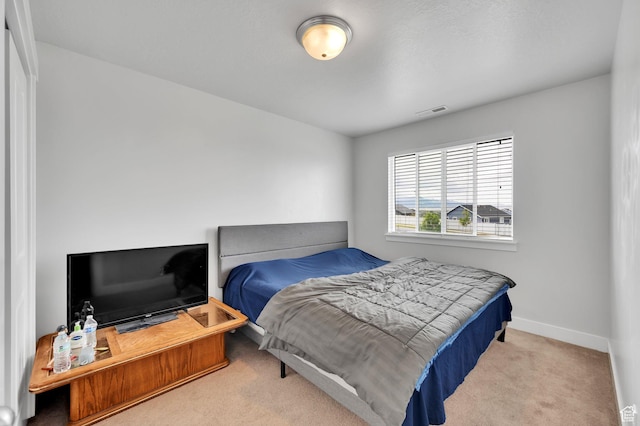 bedroom with carpet flooring and baseboards