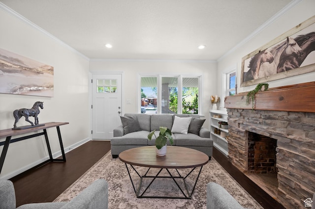 living room featuring wood finished floors, ornamental molding, baseboards, a fireplace, and recessed lighting