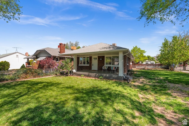 rear view of property with brick siding and a chimney