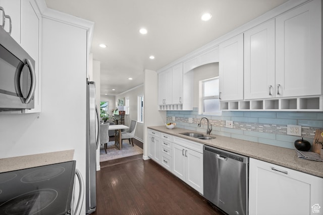 kitchen featuring appliances with stainless steel finishes, a sink, dark wood-style floors, backsplash, and recessed lighting