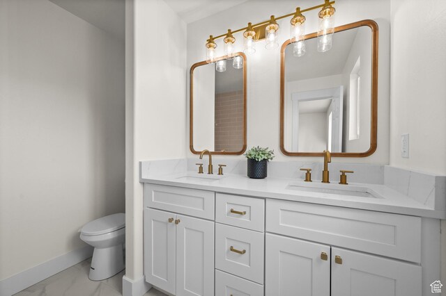 850 E Village Rd N, Ogden, UT 84404 - full bathroom featuring marble finish flooring, baseboards, toilet, and double vanity