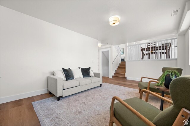 850 E Village Rd N, Ogden, UT 84404 - living room with baseboards, wood finished floors, and stairs