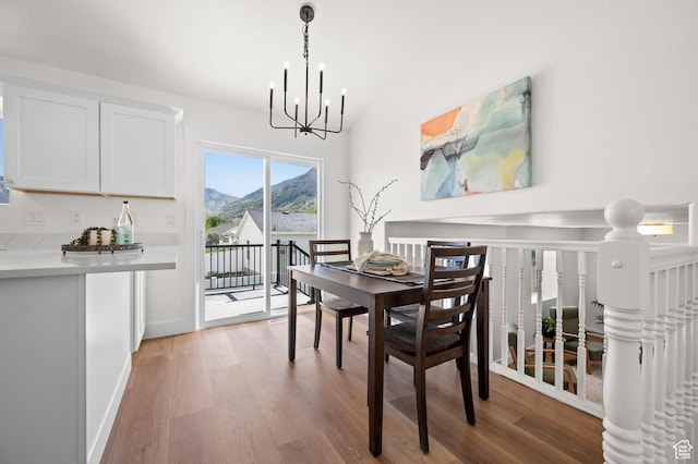 850 E Village Rd N, Ogden, UT 84404 - dining space featuring a chandelier, light wood-style floors, a mountain view, and baseboards