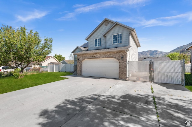 850 E Village Rd N, Ogden, UT 84404 - traditional home featuring a gate, concrete driveway, an attached garage, and brick siding