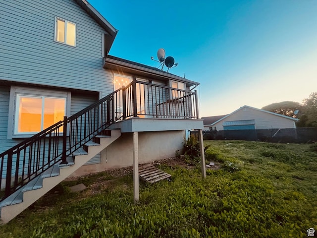 850 E Village Rd N, Ogden, UT 84404 - back of property at dusk with stairway and a lawn