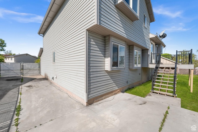 850 E Village Rd N, Ogden, UT 84404 - view of side of home featuring stairway, a patio area, a wooden deck, and a gate