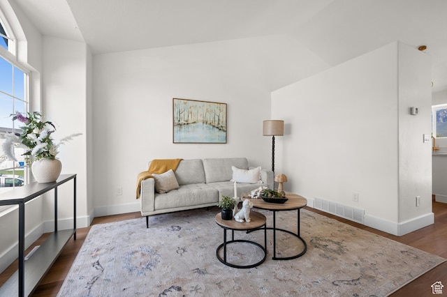 850 E Village Rd N, Ogden, UT 84404 - living room featuring lofted ceiling, wood finished floors, and baseboards