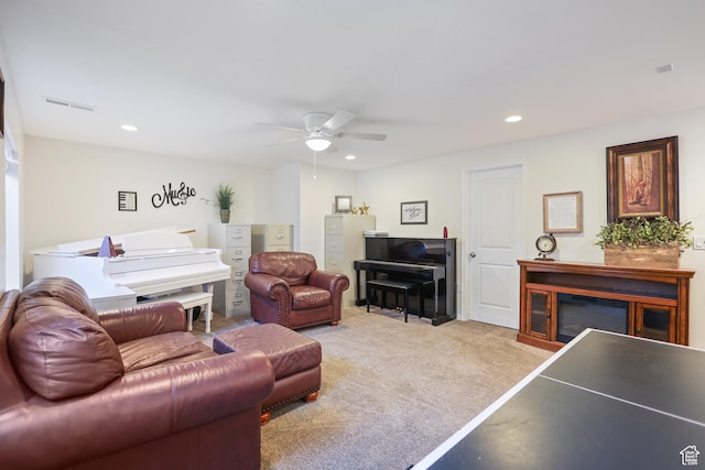 living area featuring a ceiling fan, recessed lighting, and light colored carpet