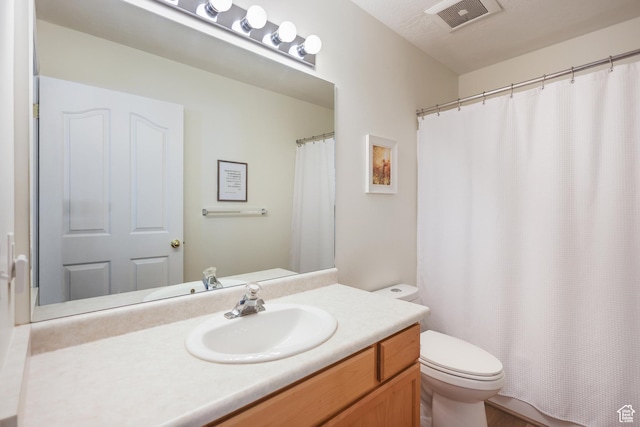 bathroom with toilet, vanity, and a shower with curtain