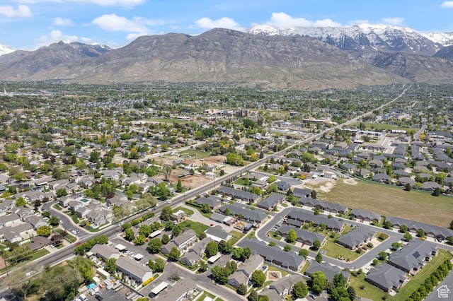 aerial view of property and surrounding area with a mountainous background and nearby suburban area