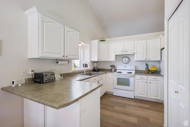 kitchen featuring white range with electric stovetop, a sink, a peninsula, white cabinets, and high vaulted ceiling