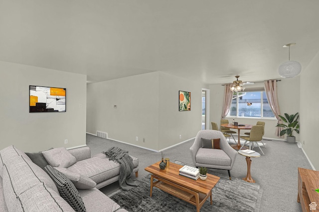 carpeted living room with baseboards and ceiling fan