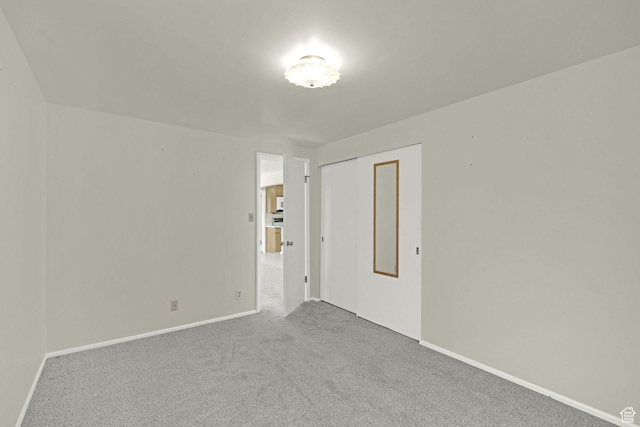 empty room with carpet and baseboards