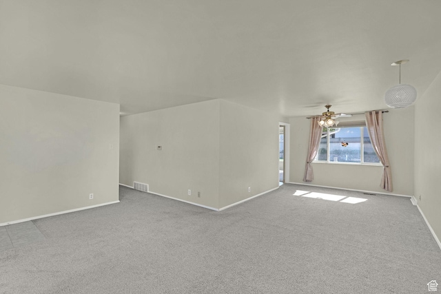 unfurnished living room with carpet floors, baseboards, and a ceiling fan