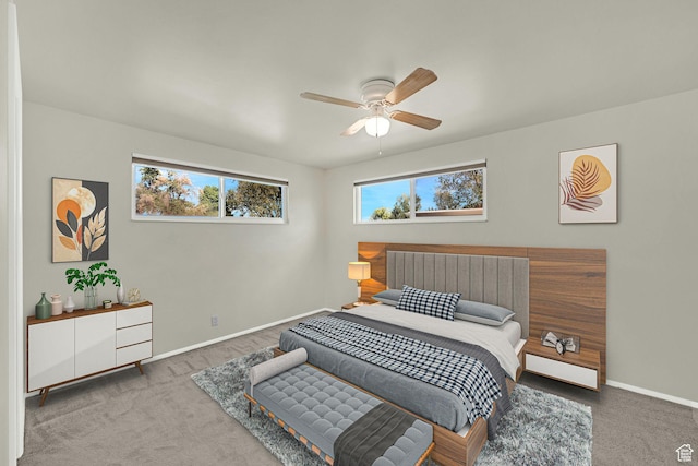 carpeted bedroom with baseboards and a ceiling fan