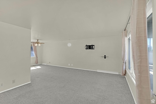 empty room with carpet flooring, baseboards, and a ceiling fan