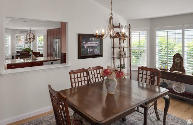 6721 S Costa Cv E, Cottonwood Heights, UT 84121 - dining room with a chandelier, wood finished floors, lofted ceiling, and baseboards