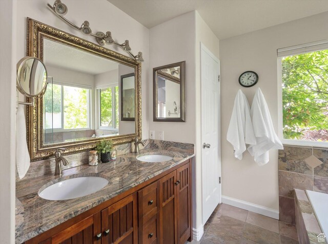 6721 S Costa Cv E, Cottonwood Heights, UT 84121 - full bath featuring double vanity, baseboards, and a relaxing tiled tub