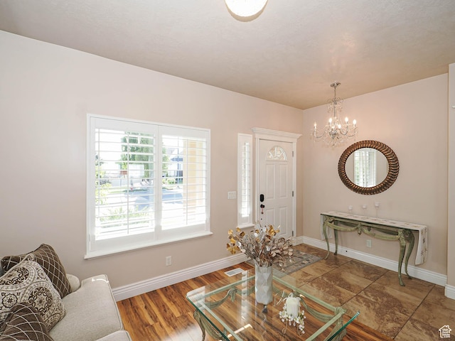 7956 S Cricket Ln W, West Jordan, UT 84081 - living room with a chandelier, baseboards, and wood finished floors