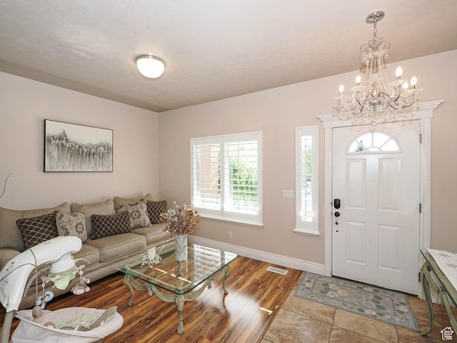 7956 S Cricket Ln W, West Jordan, UT 84081 - entryway featuring a chandelier, wood finished floors, and baseboards