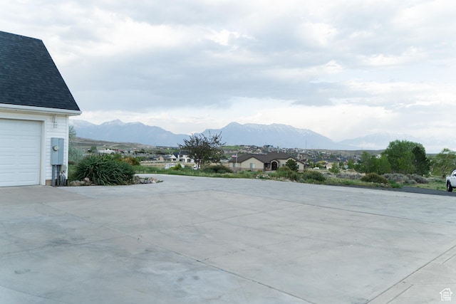 view of patio / terrace with a mountain view, driveway, and a garage