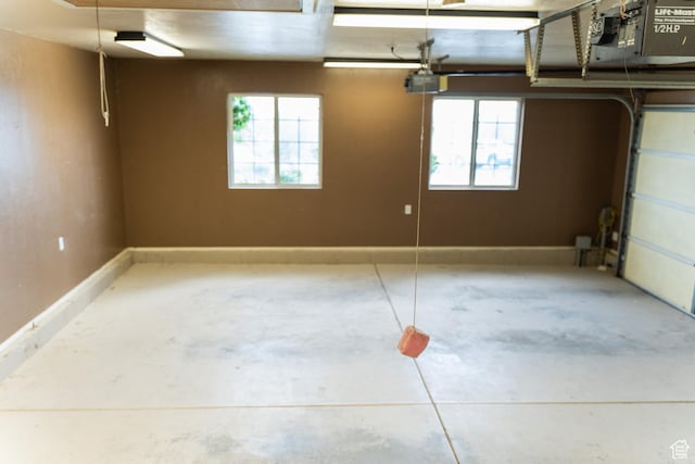 garage with a garage door opener and baseboards