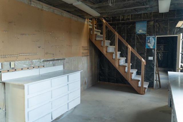 unfinished basement featuring stairs