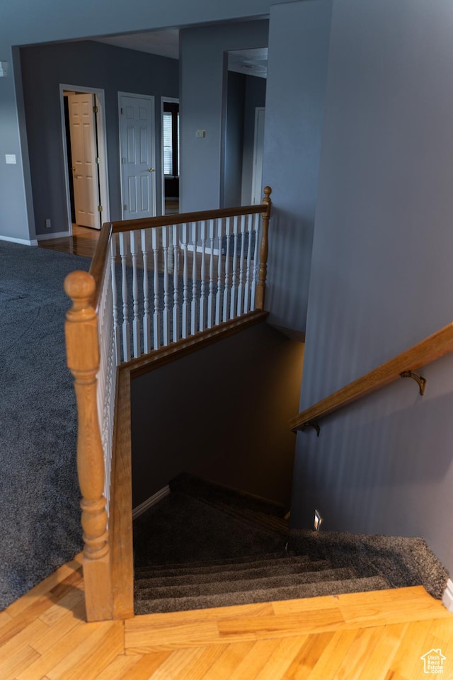 stairs featuring baseboards and carpet