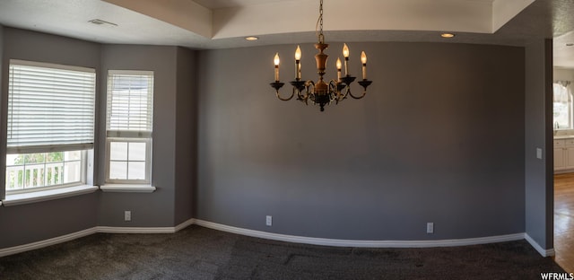 carpeted spare room featuring a chandelier, baseboards, and recessed lighting