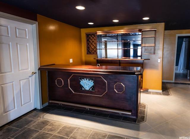 detailed view of a dry bar, baseboards, and recessed lighting