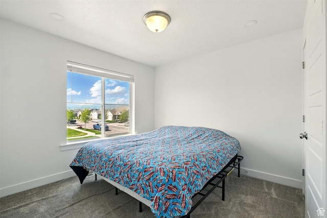 carpeted bedroom featuring baseboards