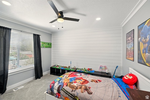 carpeted bedroom with crown molding, wooden walls, a textured ceiling, recessed lighting, and a ceiling fan